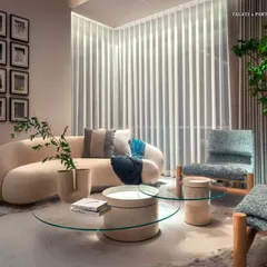 A serene seating nook within a Palais Royale bedroom, where a curved sofa and textured armchair create a moment of pause. The design balances openness with intimacy, speaking directly to those who savor luxury yet crave minimalism.