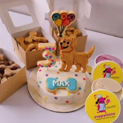 We do more than just cakes. This is Max's complete 3rd birthday package, featuring a custom Golden Retriever cake, boxes of our signature bone-shaped biscuits, and even some dog-friendly ice cream. We can create the perfect party spread for your pup.