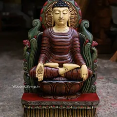 A 24-inch Buddha sculpture with an ancient look, seated on a brown lotus. The hand-painted finish uses a palette of deep reds and greens to create a sense of timeless serenity.