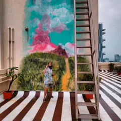 A conceptual mural on a terrace, inspired by cotton candy clouds and green meadows. This piece is about holding onto the magic and wonder of childhood.