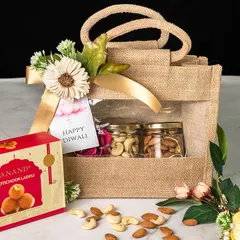 Our eco-friendly and stylish jute bags are a popular choice for corporate gifting. This Diwali gift set features a box of traditional motichoor ladoo and jars of premium nuts, beautifully arranged in a reusable windowed jute bag. It’s a tasteful and sustainable gifting option.