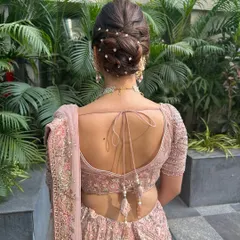 This textured bun, dotted with delicate pearls, looks like it came straight off a Pinterest board. It's a romantic and elegant choice for any bride or wedding guest.