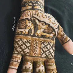 A close up of the palm featuring a pair of elephants. The fingers have small, matching elephant designs, creating a cohesive and charming theme.