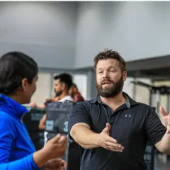 Interactive learning is key. A UKSCA trainer engages with a participant during the first day of the ASCT course, discussing the core concepts of program planning and safety.