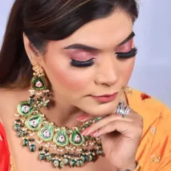 This angle shows the beautiful shimmer on the eyelids and the dramatic false lashes that make the eyes the focal point of this party makeup look.