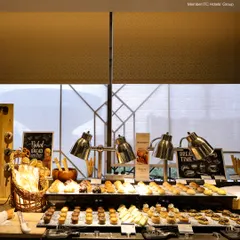 Our "Bread Time" station at the breakfast buffet, featuring an assortment of freshly baked breads, muffins, pastries, and cookies under warm heat lamps.