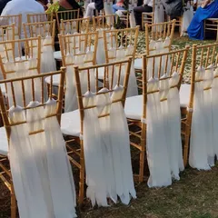Another view of the beautifully decorated Chiavari chairs. The delicate white fabric tied to the back adds a soft, romantic feel to the ceremony seating.