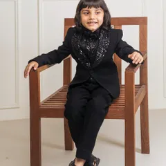 Another view of the black tuxedo with the sparkling sequin cowl neck. This design is a great option for a boy's birthday party or a New Year's Eve event.