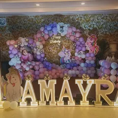 A 'My Little Pony' and unicorn theme for Aamyra's first birthday. The pastel balloon arch and large light-up letters create a dreamy photo corner.