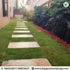 The clean lines of the stepping stone pathway cut through the vibrant green lawn, leading the eye through the newly transformed garden space.
