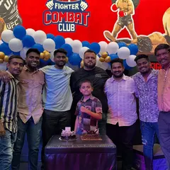 Celebrating a birthday with cake and the team. These moments build the family atmosphere that defines Fighter Combat Club.