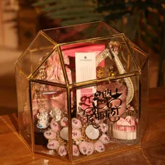 This is one of my favorite Diwali hampers, designed to feel both luxurious and festive. It’s housed in a stunning gold-trimmed glass terrarium and filled with handpicked items like decorative diyas, gourmet treats, and personalized elements.