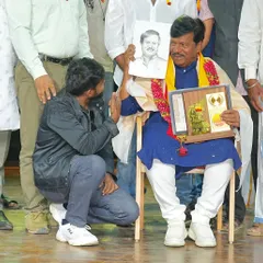 Kneeling to present a sketch to a respected guest at a cultural program. I believe in showing respect for elders and fellow artists, as is our tradition.