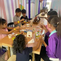 Another view of our art room, where kids are busy painting on mini canvases with easels, just like real artists.
