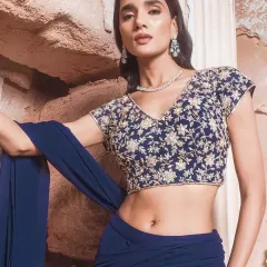 Understated does not mean underdressed. This pre-draped navy saree, paired with a sequin-embroidered blouse, is ideal for those who love sleek silhouettes and unfussy glamour. It’s an elegant choice for an evening reception or cocktail party.