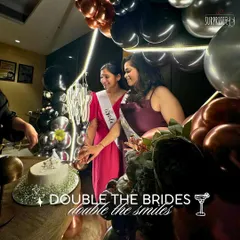 Double the brides, double the smiles! We had so much fun creating this joint bachelorette party setup. The brides are seen here cutting their cake in front of our custom balloon arch.