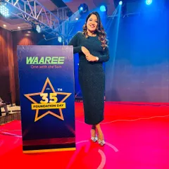 Posing by the 35th Foundation Day branding for Waaree Group. I enjoy hosting corporate milestones and celebrating a company's journey of excellence.