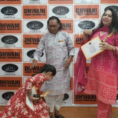 A beautiful moment of respect. A young student touches her guru's feet after receiving her award, a gesture that reflects the deep cultural values we impart alongside artistic training.