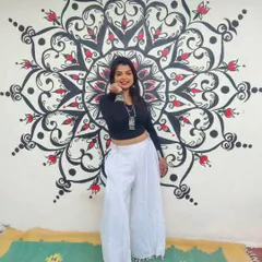 Here I am with a finished mandala mural I created for a client's party area. I design these pieces to be a focal point, using bold lines and intricate patterns to create a sense of balance and energy in the space. This is a great example of my custom mandala wall art.
