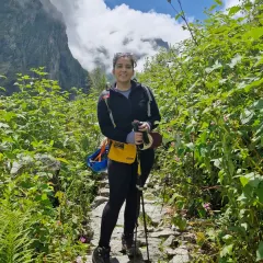 Pausing on a narrow stone path during my trek. The journey was challenging, but moments like these, surrounded by the immense beauty of the Himalayas, made it all worth it.