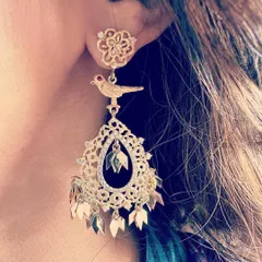 The 'Birds of Paradise' earring, a large and dramatic piece that remains light and breezy. It combines filigree, a bird motif, and dangling gold leaves for lots of movement and shine.