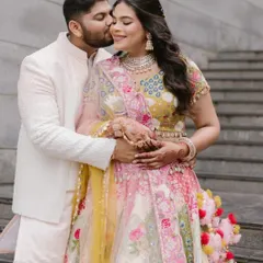 A sweet moment between the couple during a pre-wedding ceremony. Her makeup is soft and romantic.