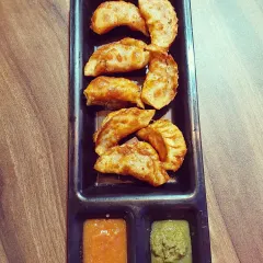 Our crunchy fried momos served with two special chutneys. One is a classic red chilli dip, and the other is a fiery Raja Marcha (Bhut Jolokia) chutney for those who like it extra spicy.