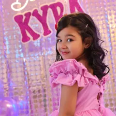 A charming over-the-shoulder glance from the birthday girl. Our approach to kids' photography is to engage with them and capture their natural personality.