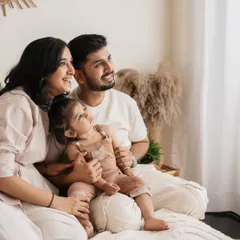 A candid family portrait where everyone is looking out the window, bathed in soft, natural light.