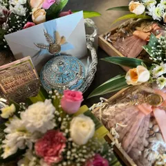 This bespoke Samdhi invitation hamper is a grand gesture of respect and love. It features an ornate silver tray holding a beautiful invitation card, intricately designed gift boxes, and a fresh flower arrangement to welcome the new family.