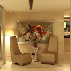 A view of one of our stylish waiting areas, complete with modern furniture and captivating artwork. Every corner of our salon is designed to create a sense of luxury and artistic flair.