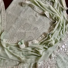 A complete view of the mint green suit, showing the interplay between the dense Chikankari on the kurta and the bold mirrorwork on the palazzo and dupatta.