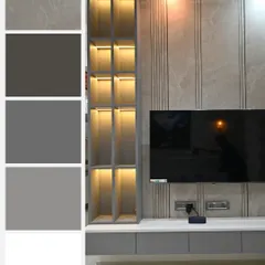 This TV unit showcases a cool, contemporary grey color palette. The back wall features a combination of fluted panels and smooth laminate, with a built-in open shelving unit illuminated by warm backlighting.