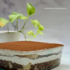 A close-up of my classic Tiramisu tub. You can see the distinct layers of coffee-soaked ladyfingers and creamy mascarpone, all dusted with premium cocoa powder. It's a little tub of happiness.