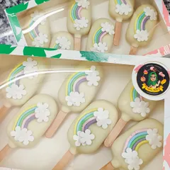 These rainbow-themed cakesicles are perfect for adding a pop of colour and magic to any party. Each one is coated in white chocolate and decorated with a pastel rainbow and fluffy fondant clouds.