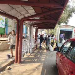 A view of the new rickshaw stand shelter under construction. This structure was a key element of the plan, designed to provide weather protection and create an organized queuing system for commuters.
