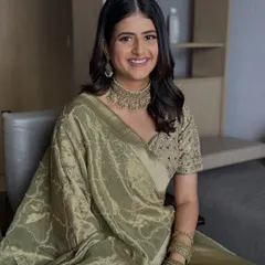 A seated portrait showing the complete look. The soft waves and natural makeup create an aura of effortless elegance for her engagement day.