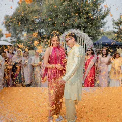 The moment of "phoolon ki haldi"! This shot captures the sheer joy and chaos of being showered with marigold petals at the ITC Grand Bharat.