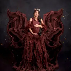 Feeling like an angel. The ruffled maroon gown is styled to create beautiful, wing-like shapes, giving this portrait a dramatic and enchanting feel. I love bringing a client's vision to life.