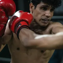 A close up shot of a fighter executing a powerful right cross during a drill. We break down every movement, focusing on generating power from the ground up for maximum impact in your boxing and Muay Thai striking.