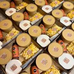 Here you can see an assembly line of my kids' party boxes getting ready for a birthday celebration. The consistent and neat packaging ensures every child feels equally special.
