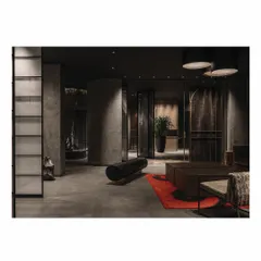 The foyer of our 'Frozen' retail project features a raw, burnt log of wood used as a bench. This piece introduces an element of nature and raw beauty into a highly polished, modern space, creating an interesting and unexpected contrast.