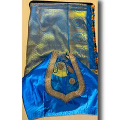 A full view of a blue silk saree paired with its custom-stitched blouse. The blouse's simple, elegant neckline with beadwork is designed to complement the saree without overpowering it.