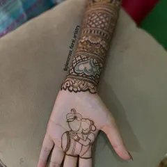 I love making your mehendi personal. Here, I created a custom portrait of the couple, a unique and sweet way to tell their love story right on the bride's palm.
