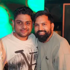 Posing for a photo with a friend and fellow artist at the club. The music industry is built on these connections and friendships.