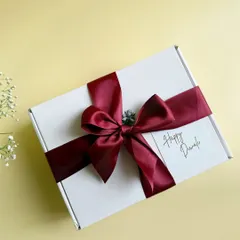 Simple, elegant, and heartfelt. This beautifully wrapped Diwali gift box with a rich maroon satin ribbon is perfect for conveying warm festive wishes to clients and employees.