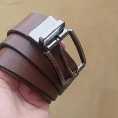 A look at the smooth brown leather side of my reversible belt, coiled to show its flexibility and quality.