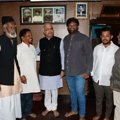 A group photo with Dr. Vinay Sahasrabuddhe and members of our family and artisan community inside our workshop. The portraits on the wall are of our ancestors who started this tradition.