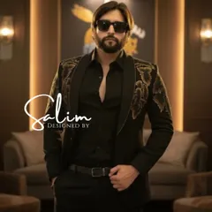 A modern, edgy look for a party or reception. This black jacket features intricate gold floral embroidery on the shoulders, worn over a classic black shirt for a sleek, high-fashion aesthetic.