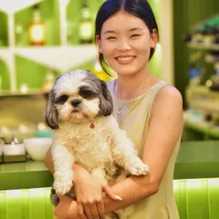 A beautiful portrait of a pet owner and her adorable dog. This shot captures the clear love and connection between them, making for a heartwarming memory.